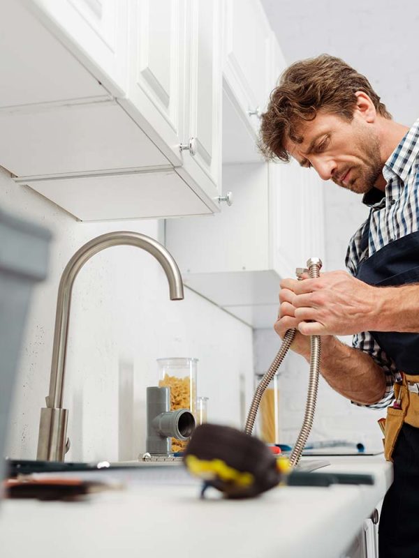 selective-focus-of-plumber-holding-metal-pipe-near-resize.jpg